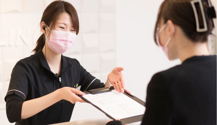 費用について説明する受付スタッフ